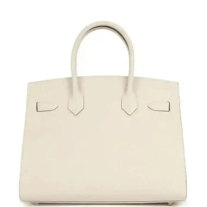 Light cream leather handbag with centered tab details and top handles