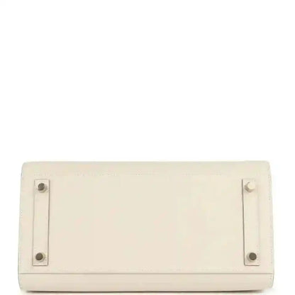 Light cream leather handbag with rear flap and stud hardware