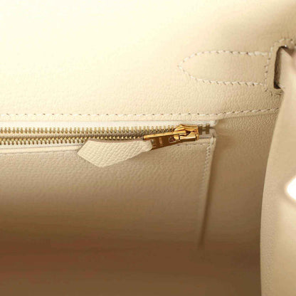 Light cream leather handbag with gold zipper and inner pocket opening