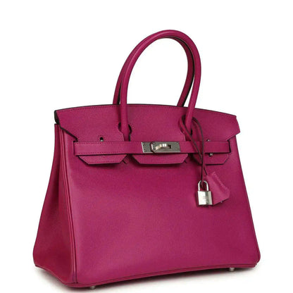 Rose-purple pebbled leather handbag with top handles, front flap, and silver lock