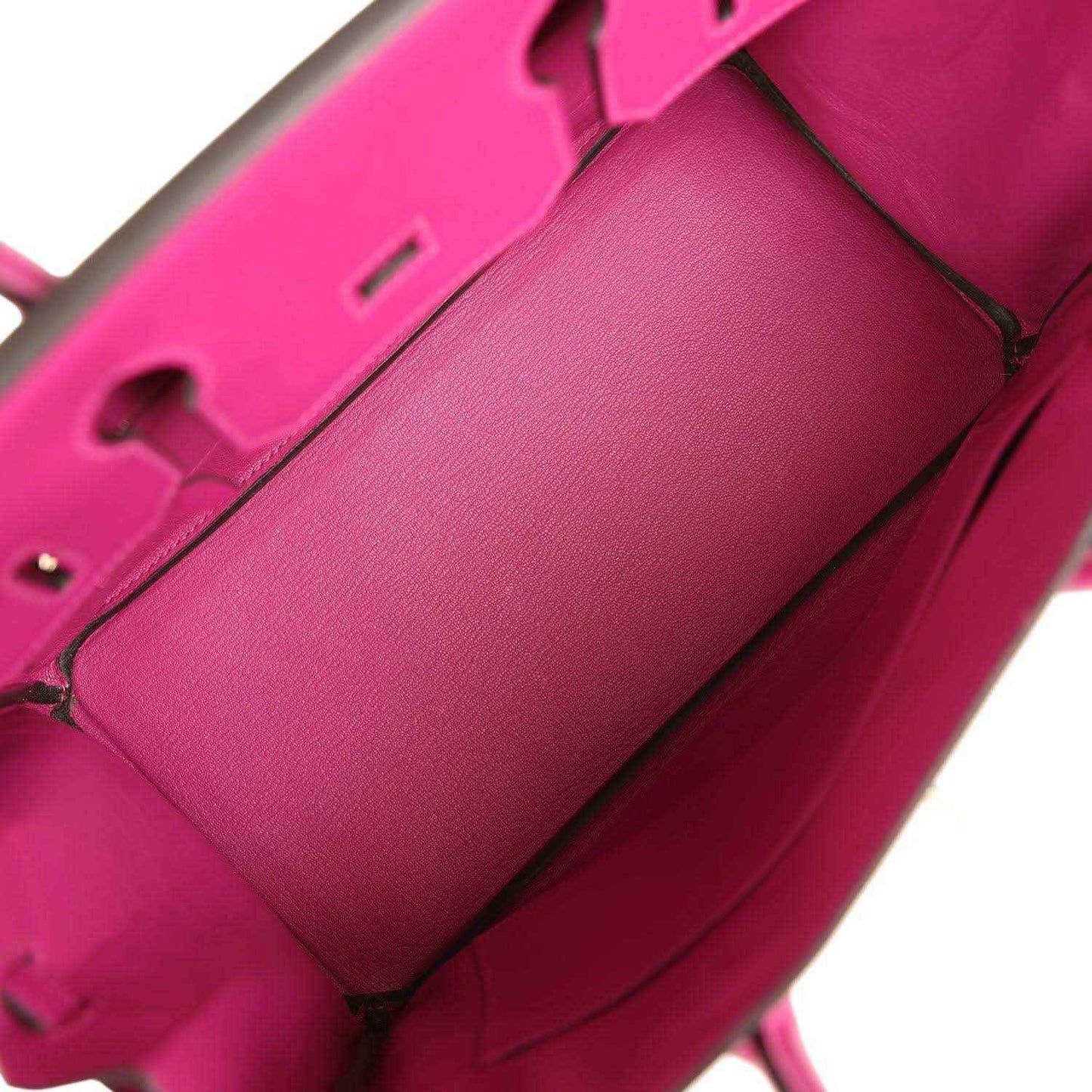 Rose-purple leather-lined interior with partition panel and visible seam stitching