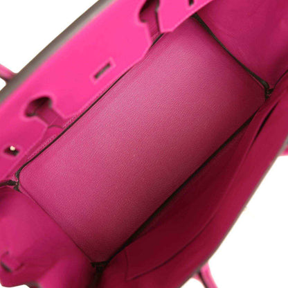 Rose-purple leather-lined interior with partition panel and visible seam stitching