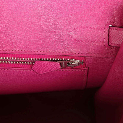 Rose-purple leather interior with zipper pull and small pocket detail
