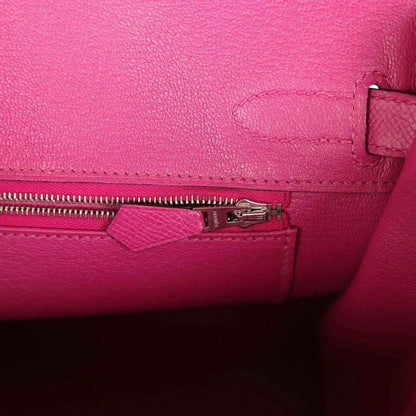 Rose-purple leather interior with zipper pull and small pocket detail