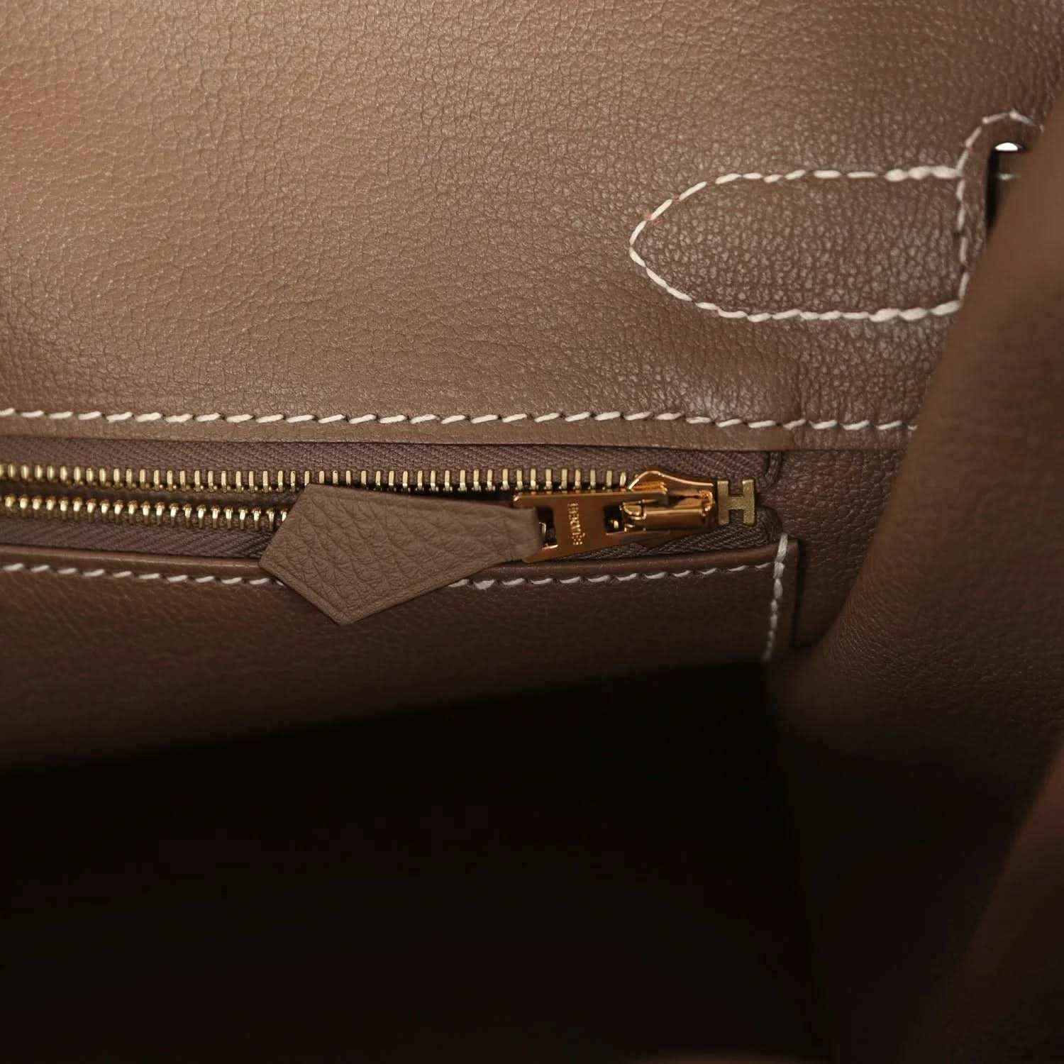 Birkin interior zipper with gold-tone pull tab on taupe Togo leather.