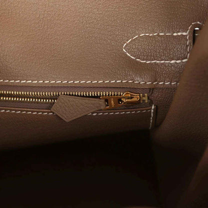 Birkin interior zipper with gold-tone pull tab on taupe Togo leather.