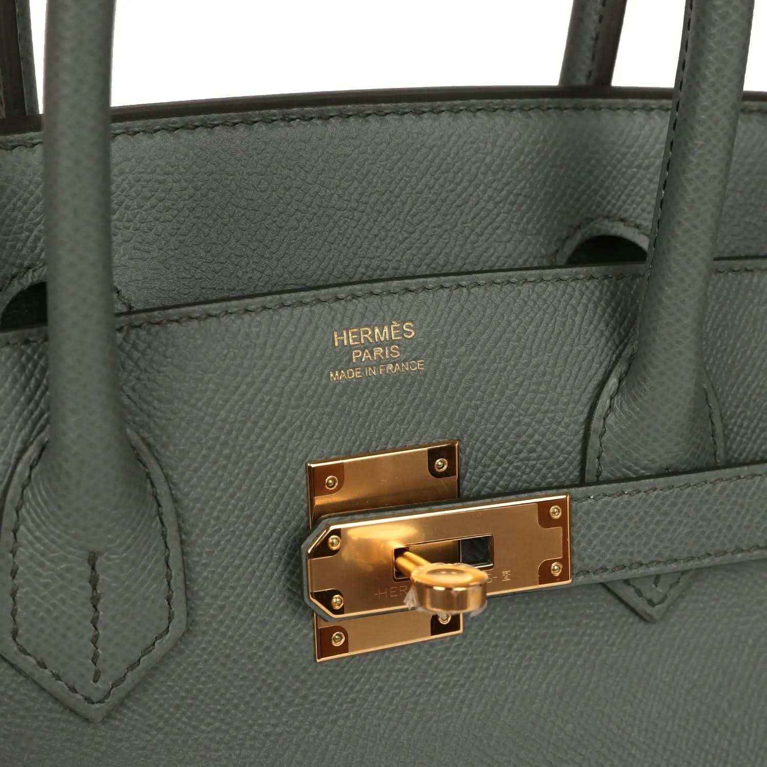 Hermes Birkin handbag interior side with Hermes stamp and gold-tone turnlock on green leather