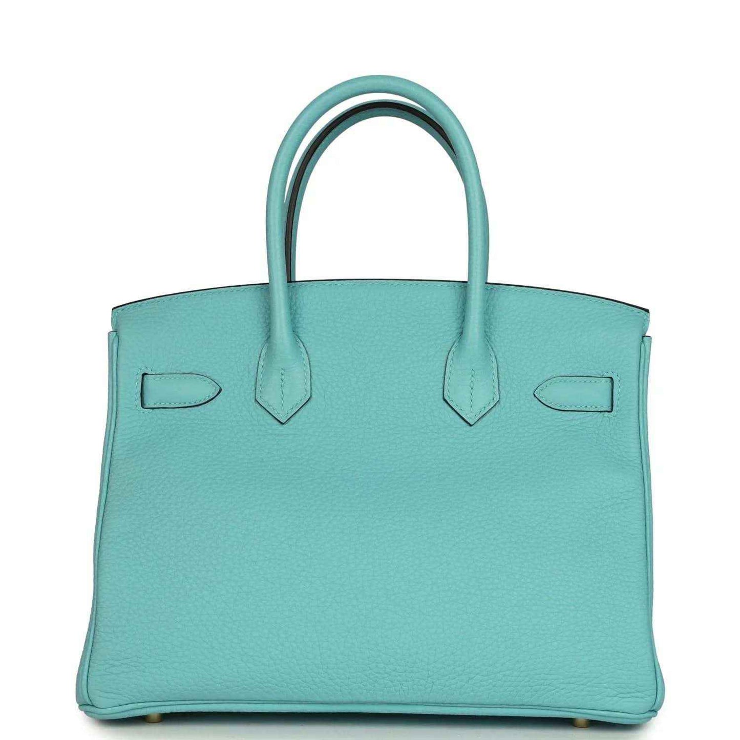 Teal leather handbag with structured sides, top handles, and gold-tone base feet
