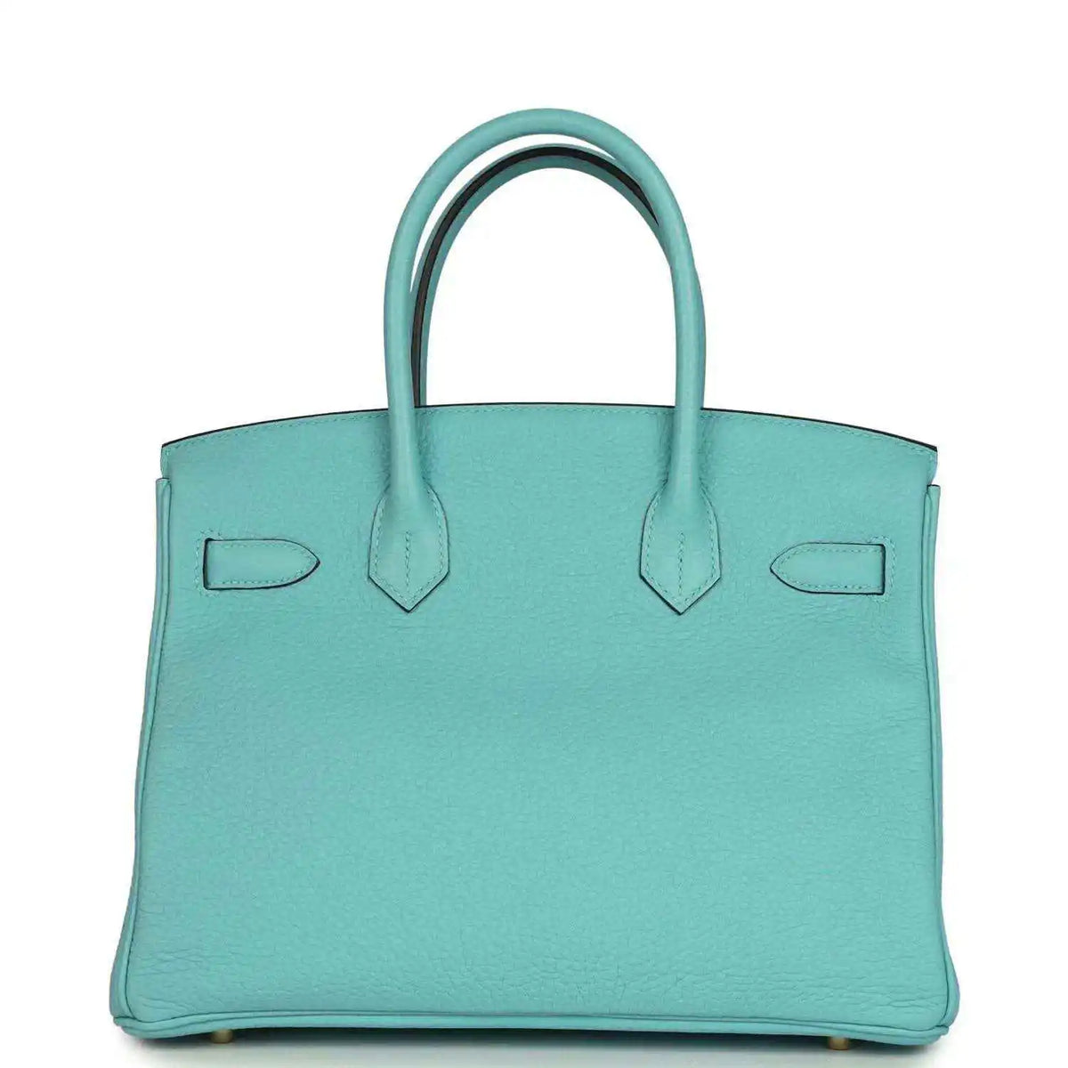 Teal leather handbag with structured sides, top handles, and gold-tone base feet
