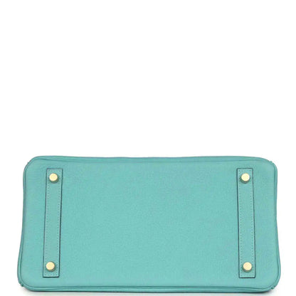 Teal leather handbag base with four corner feet, stitched edges, and snap-tab hardware