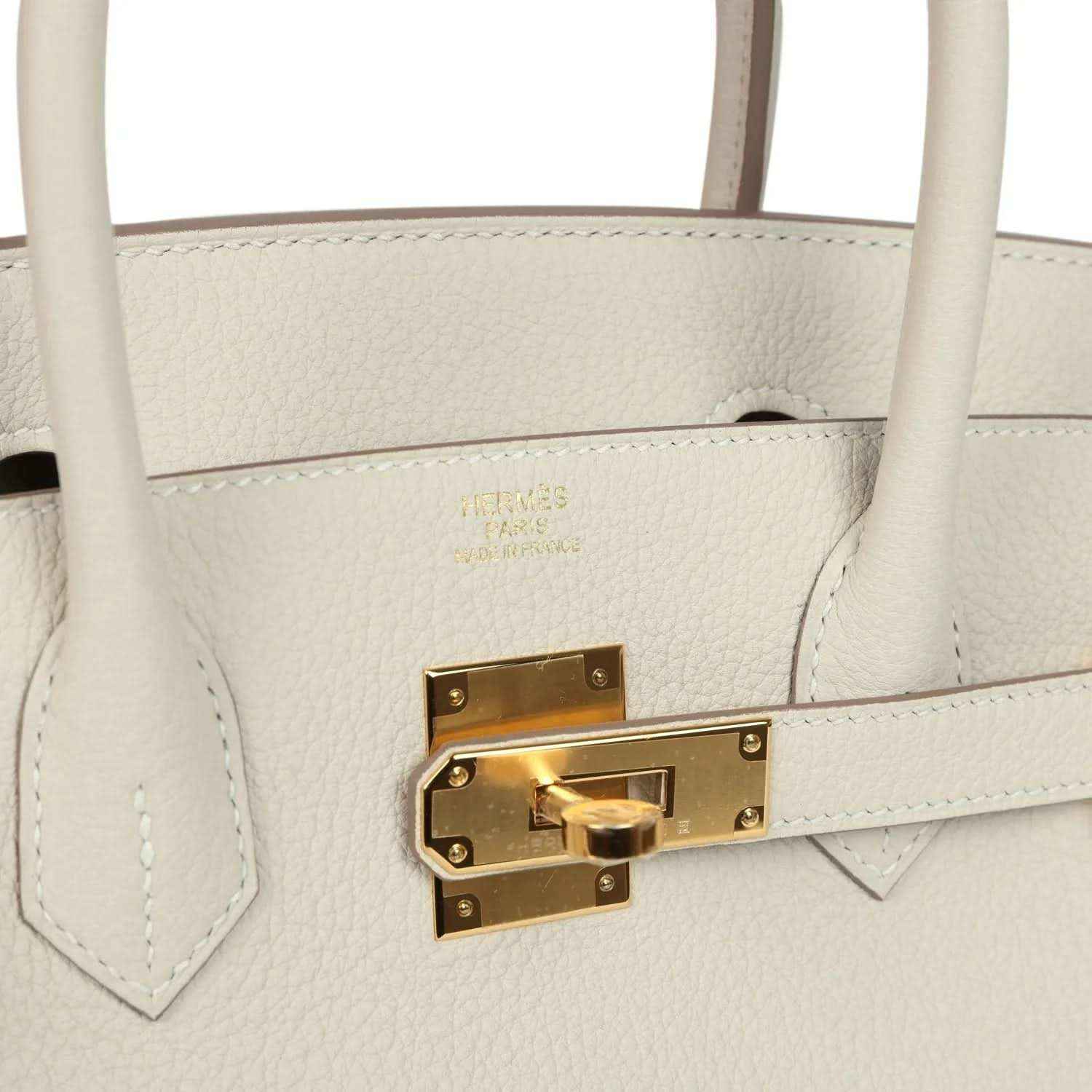Hermes Birkin 30 handbag front lock detail in light cream leather with gold hardware