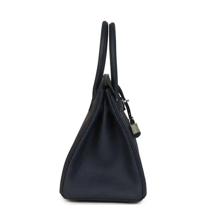 Blue leather Birkin 30 handbag, side profile with top handles and lock charm