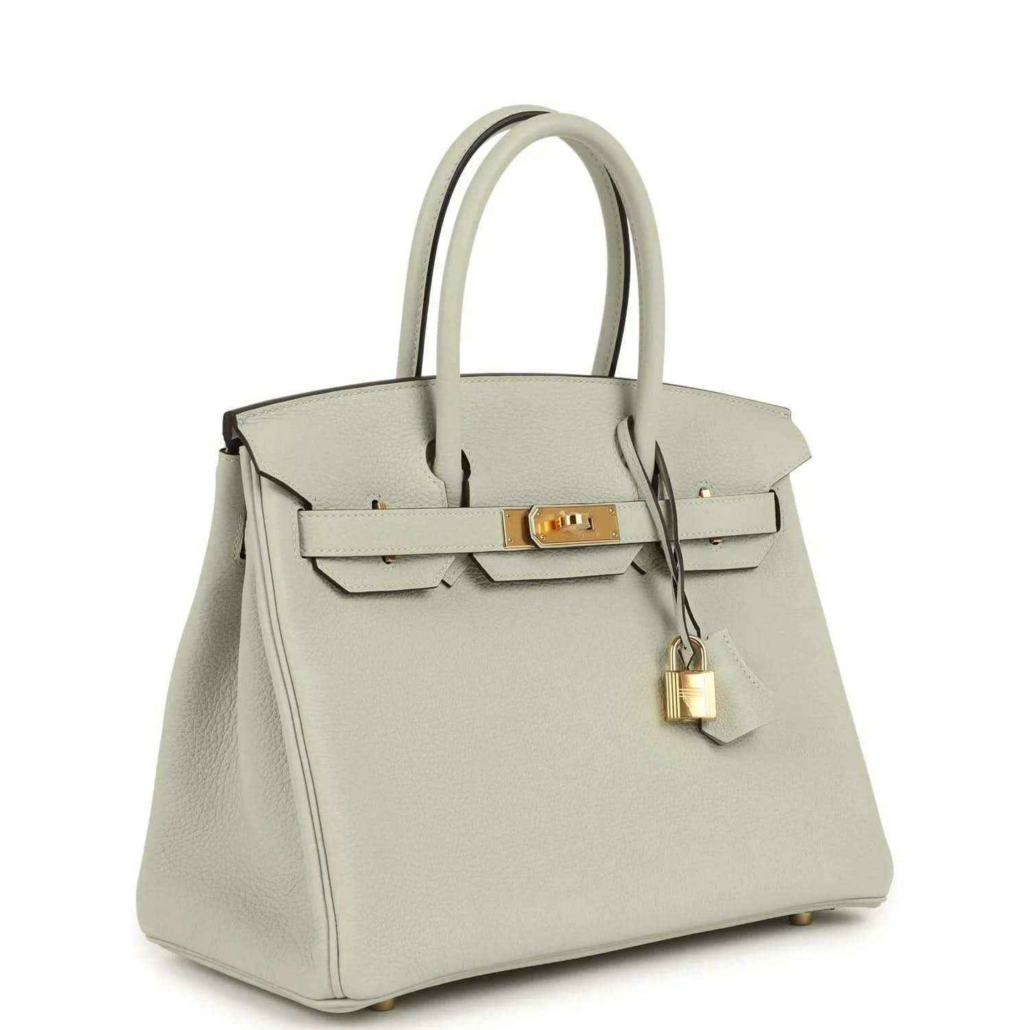 Light gray structured leather handbag with top handles, front flap, and gold lock clasp