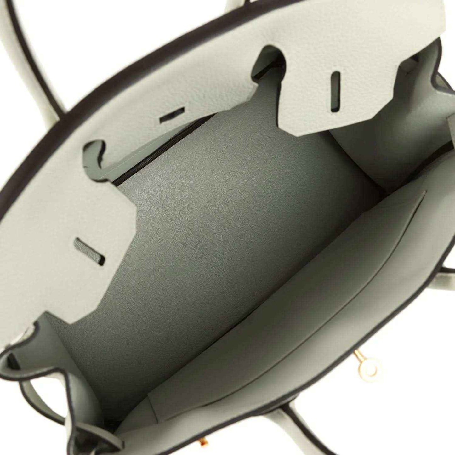 Light gray leather handbag interior with stitched lining and side compartments