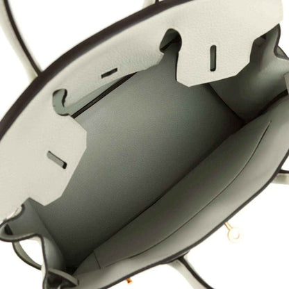 Light gray leather handbag interior with stitched lining and side compartments