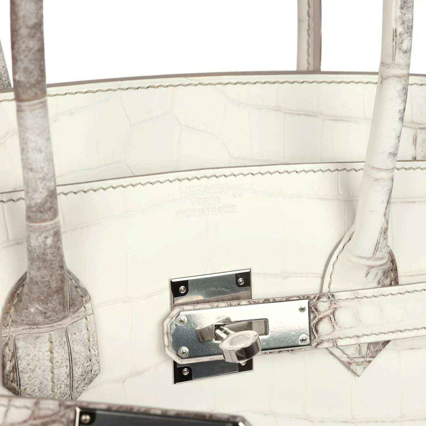 Ivory crocodile-textured handbag with metal latch lock and stitched strap tab