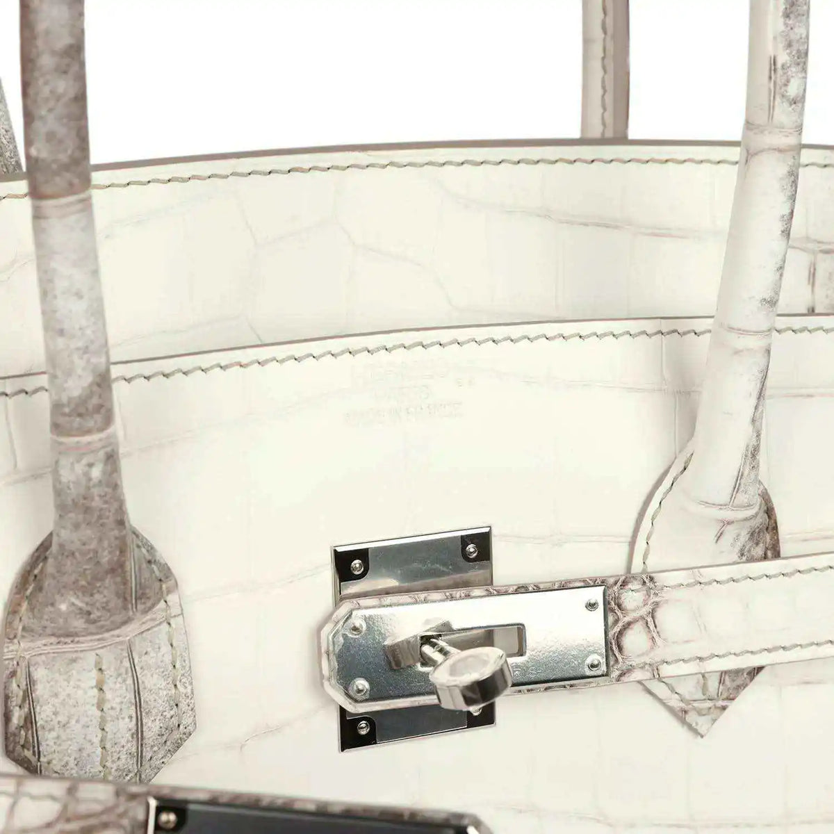 Ivory crocodile-textured handbag with metal latch lock and stitched strap tab