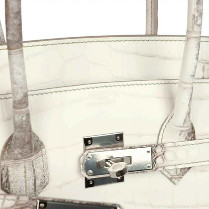 Ivory crocodile-textured handbag with metal latch lock and stitched strap tab