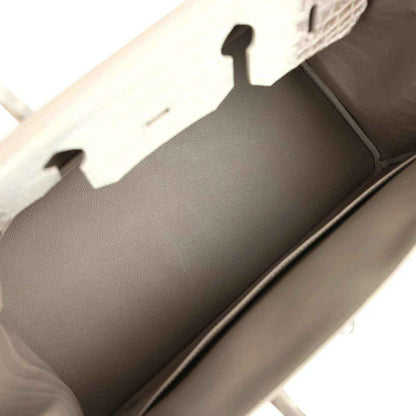 Ivory handbag interior with smooth lining and open top edge