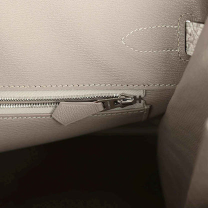 Ivory handbag interior with zipper compartment and stitched pocket edge