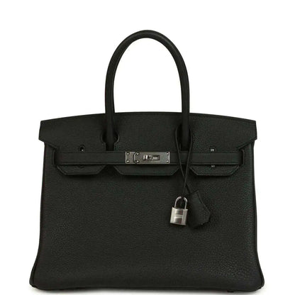 Black leather Birkin-style handbag with top handles, front flap and lock clasp detail.