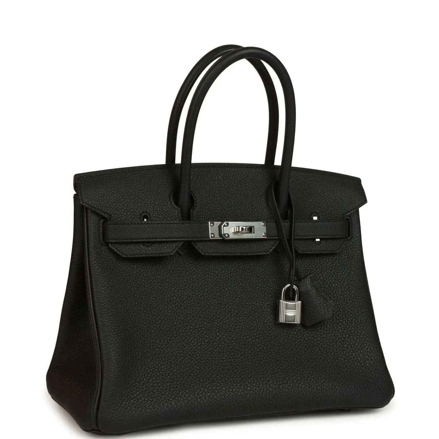 Black leather handbag with top handles, front flap and hanging lock charm on strap.