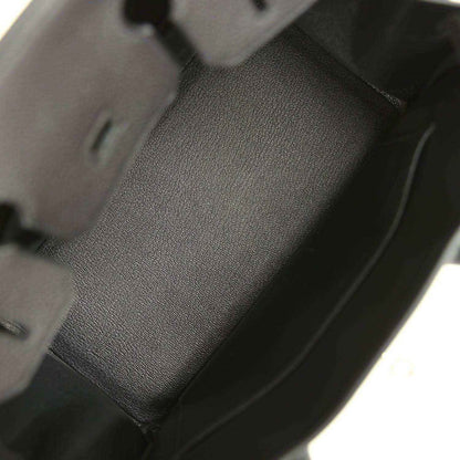 Black leather handbag interior panel with textured grain and stitched edge seams.