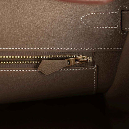 Birkin 35 handbag interior zipper pocket with gold-tone zipper pull and stitched seams