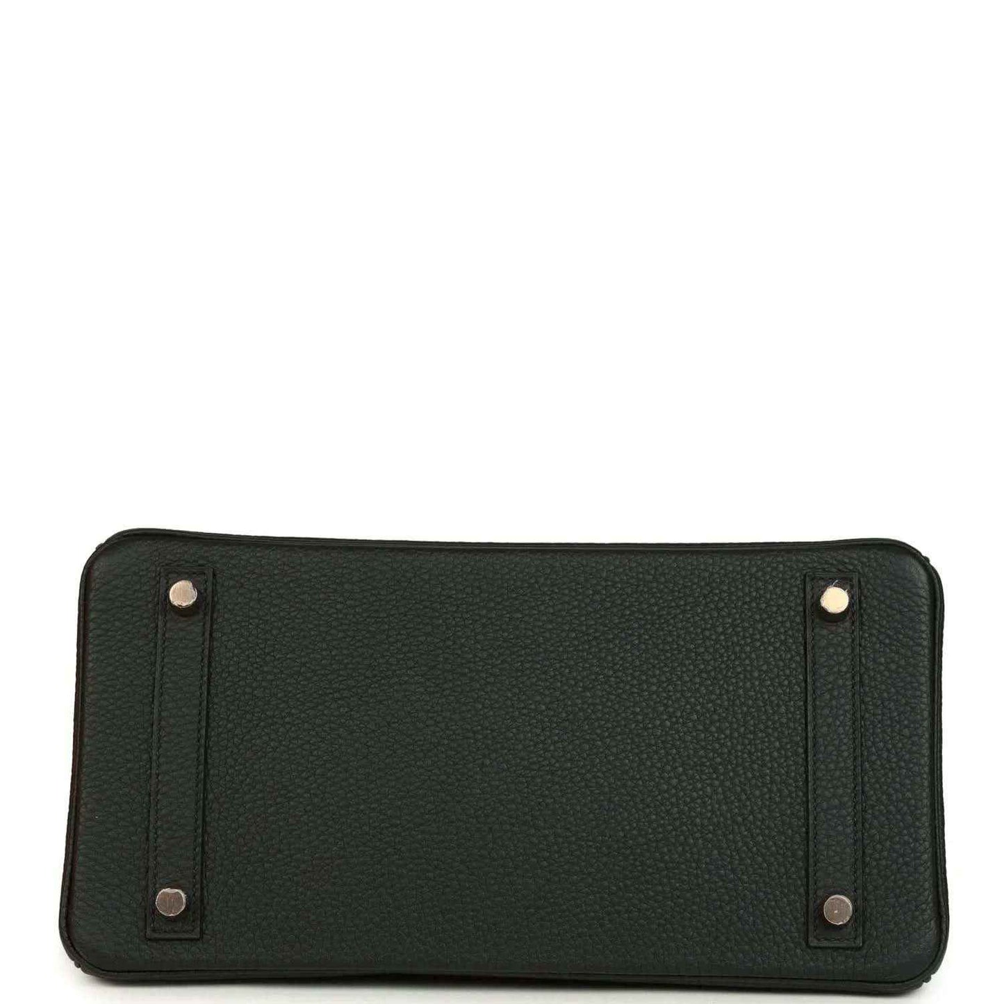 Dark green leather handbag with metal corner details and snap-secured panels