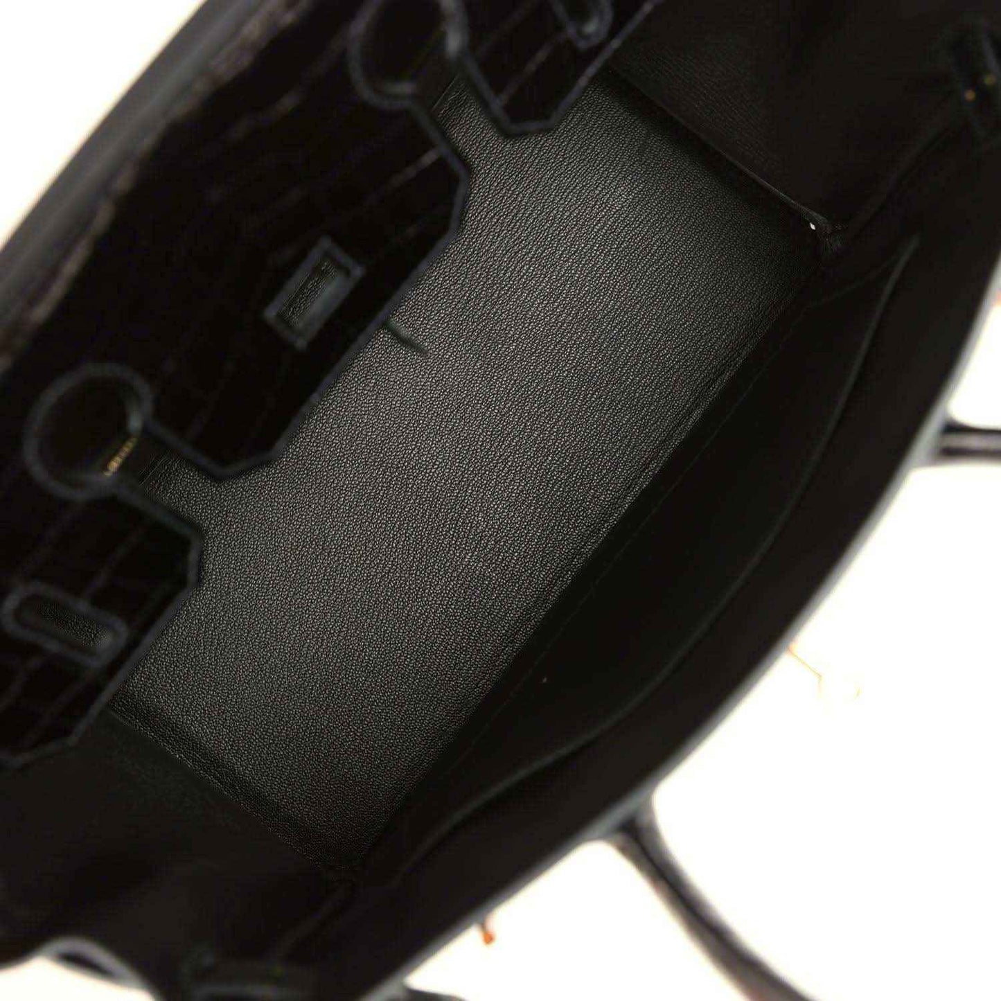 Dark green leather handbag interior with stitched lining and inner pocket