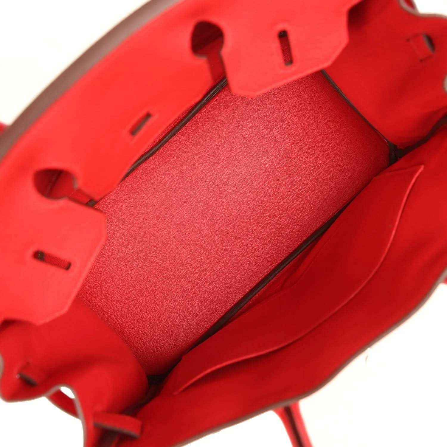 Red Togo leather Birkin bag interior with flap lining, leather tabs, and snap details.
