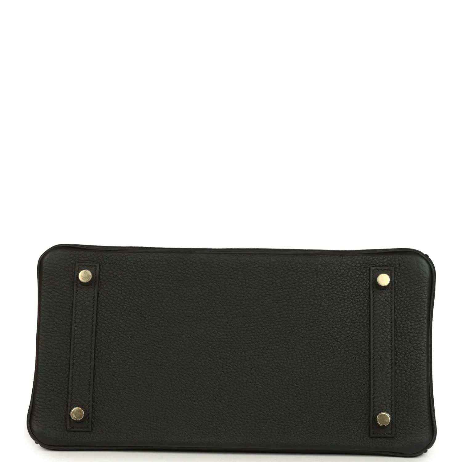 Black leather handbag with gold clasp hardware and embossed Hermes label
