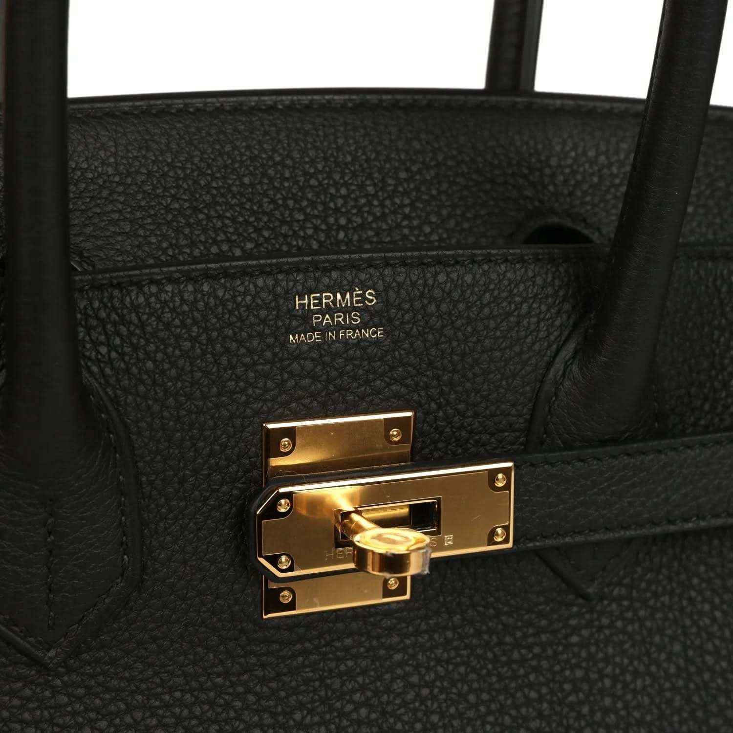 Black leather handbag interior with embossed Hermes Paris label