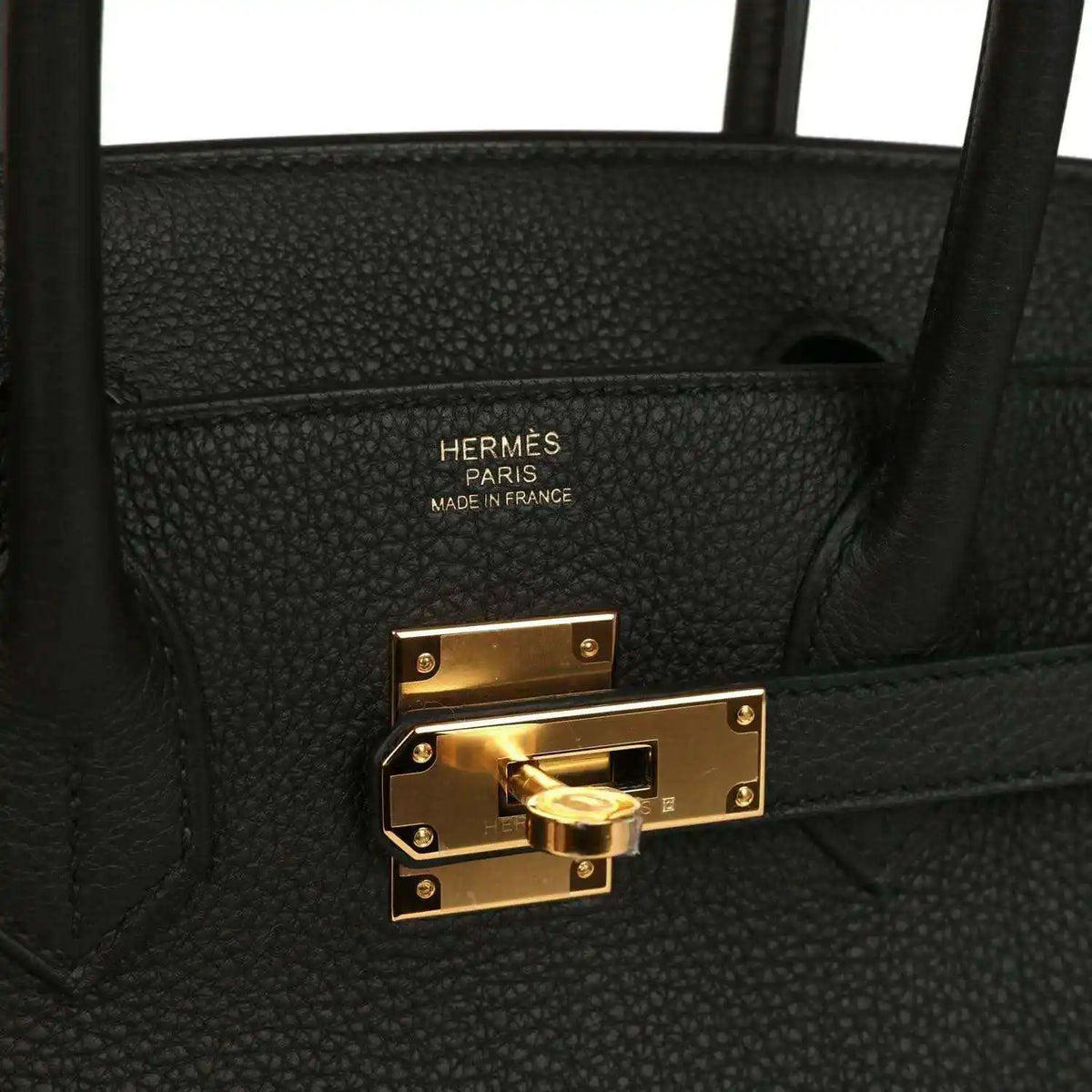 Black leather handbag interior with embossed Hermes Paris label