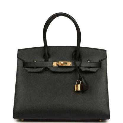 Black leather Birkin-style handbag with gold front clasp and hanging lock charm