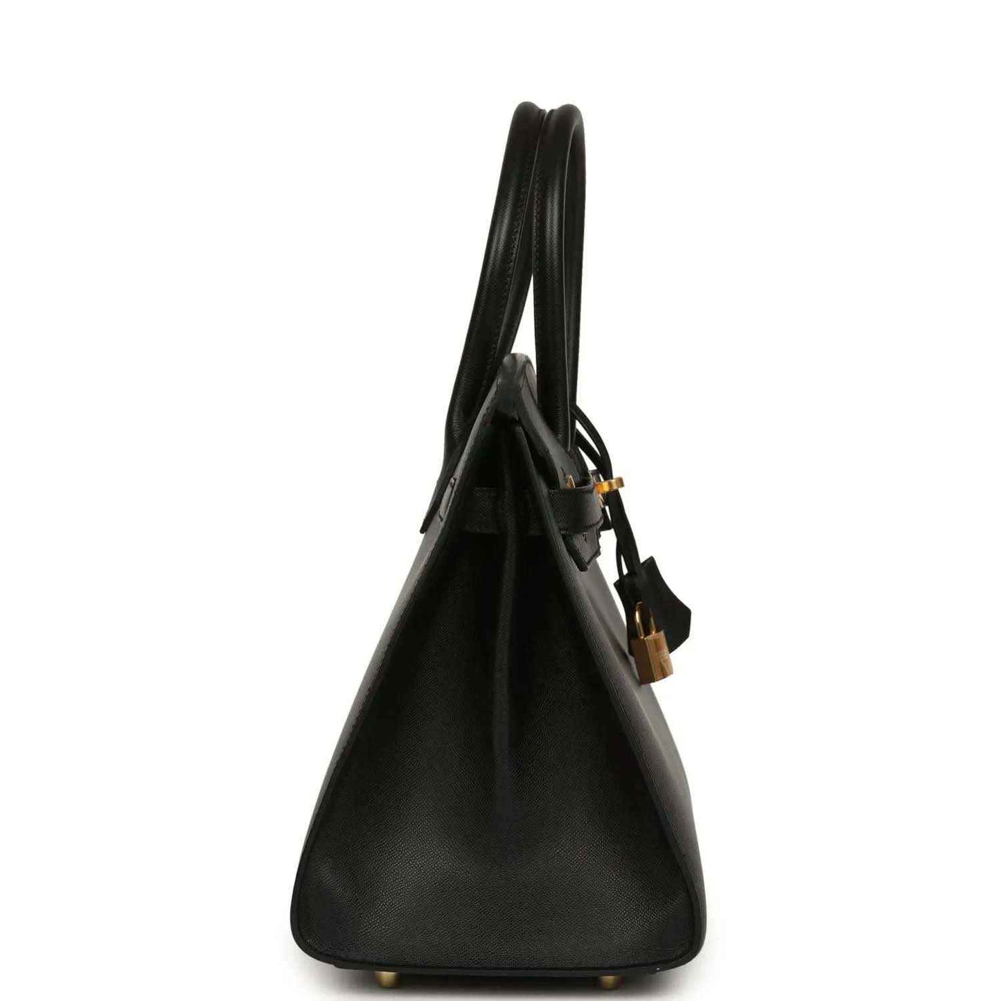 Black leather handbag side view with top handles and gold base feet