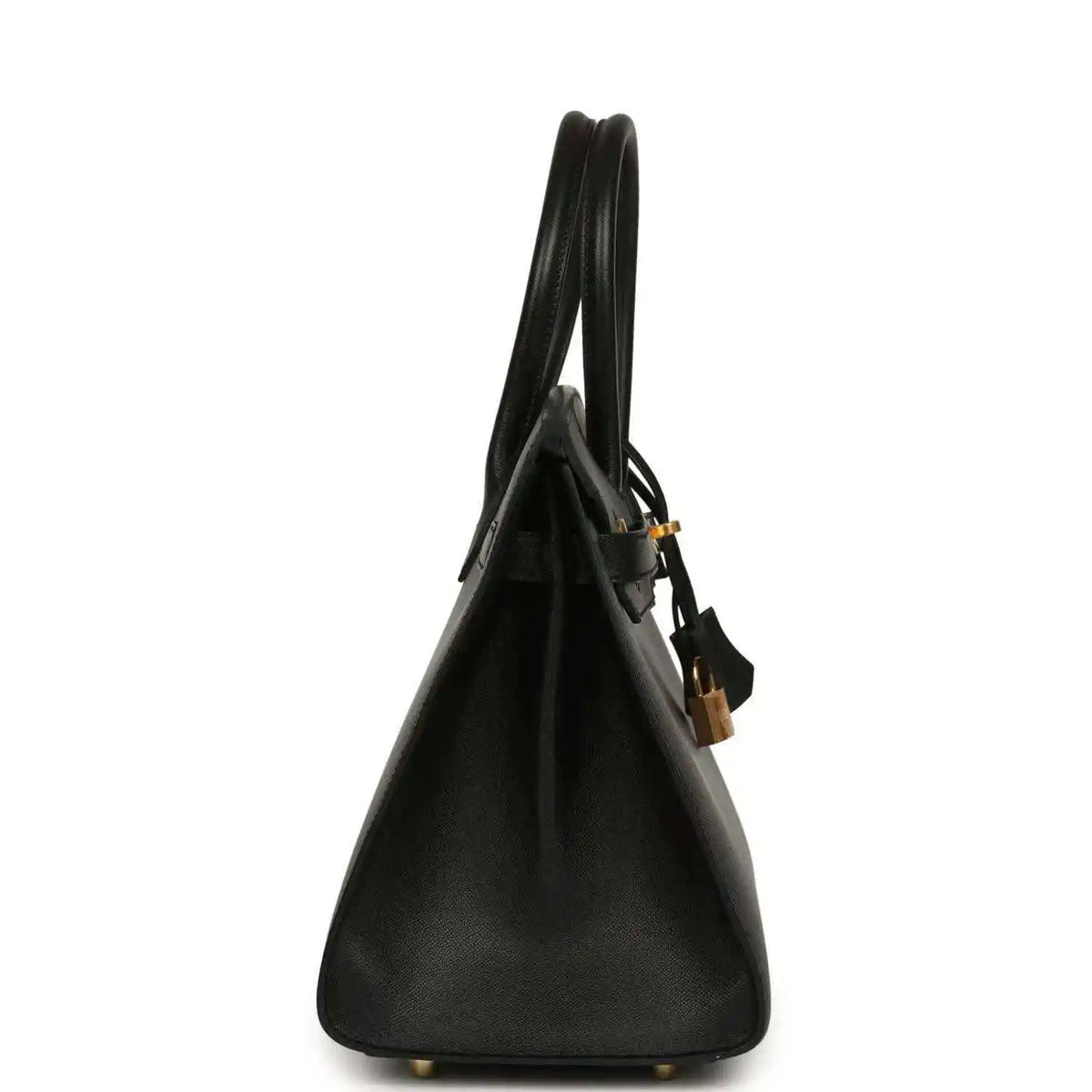 Black leather handbag side view with top handles and gold base feet