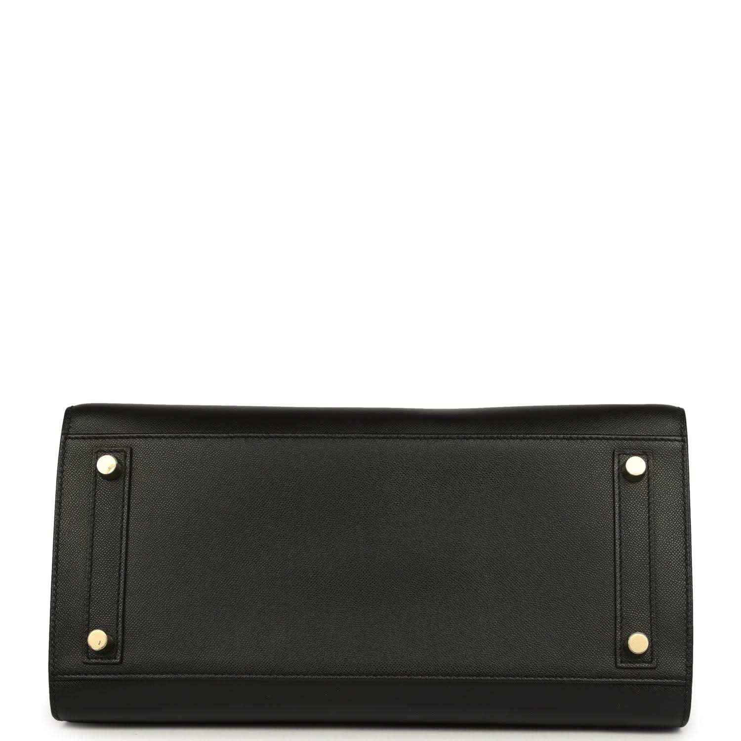 Black leather handbag with two gold corner studs on the back panel