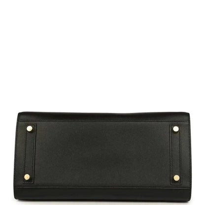 Black leather handbag with two gold corner studs on the back panel