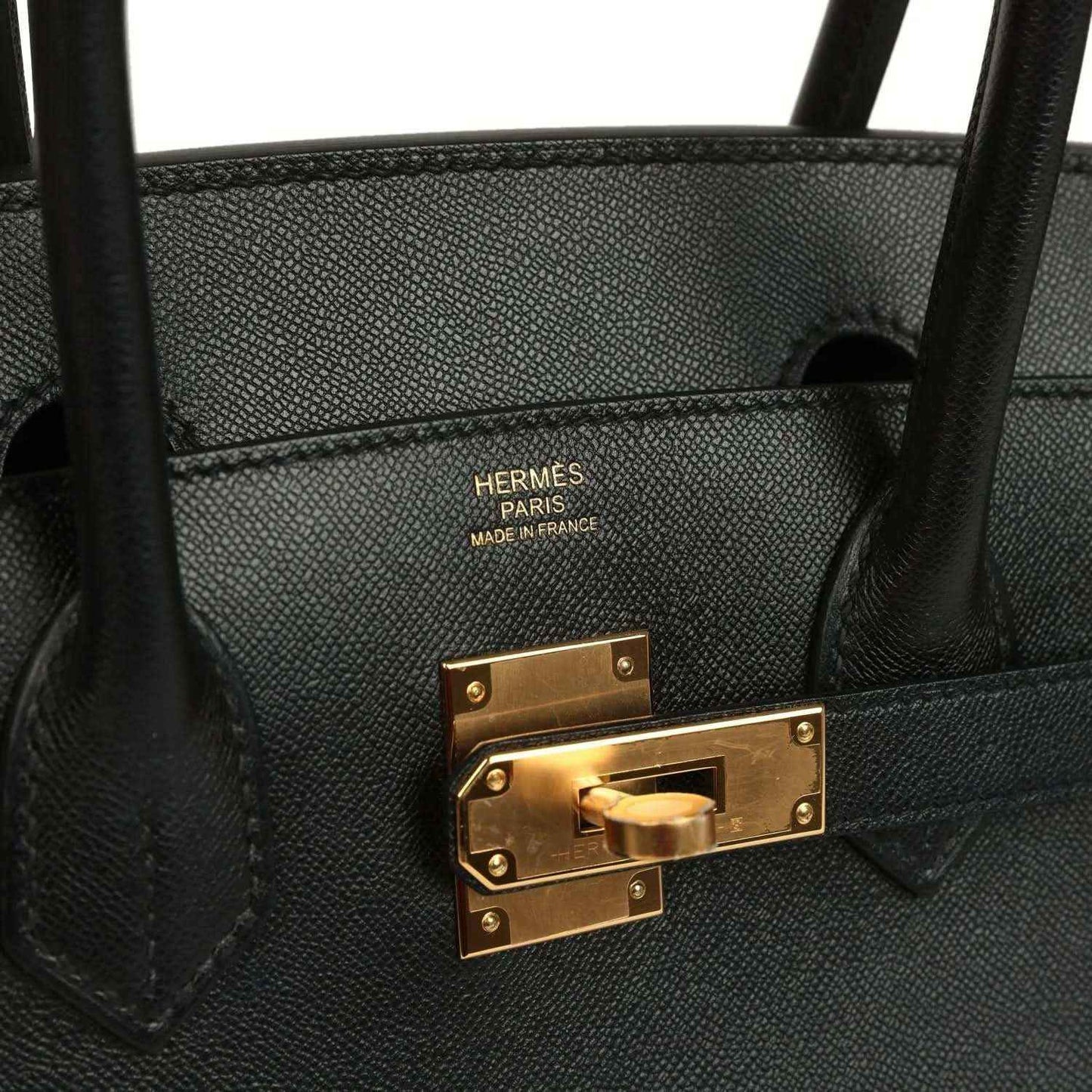 Black leather handbag interior with “HERMES PARIS MADE IN FRANCE” and gold clasp