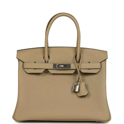 Tan Togo leather handbag with top handles, front flap, and palladium-tone lock