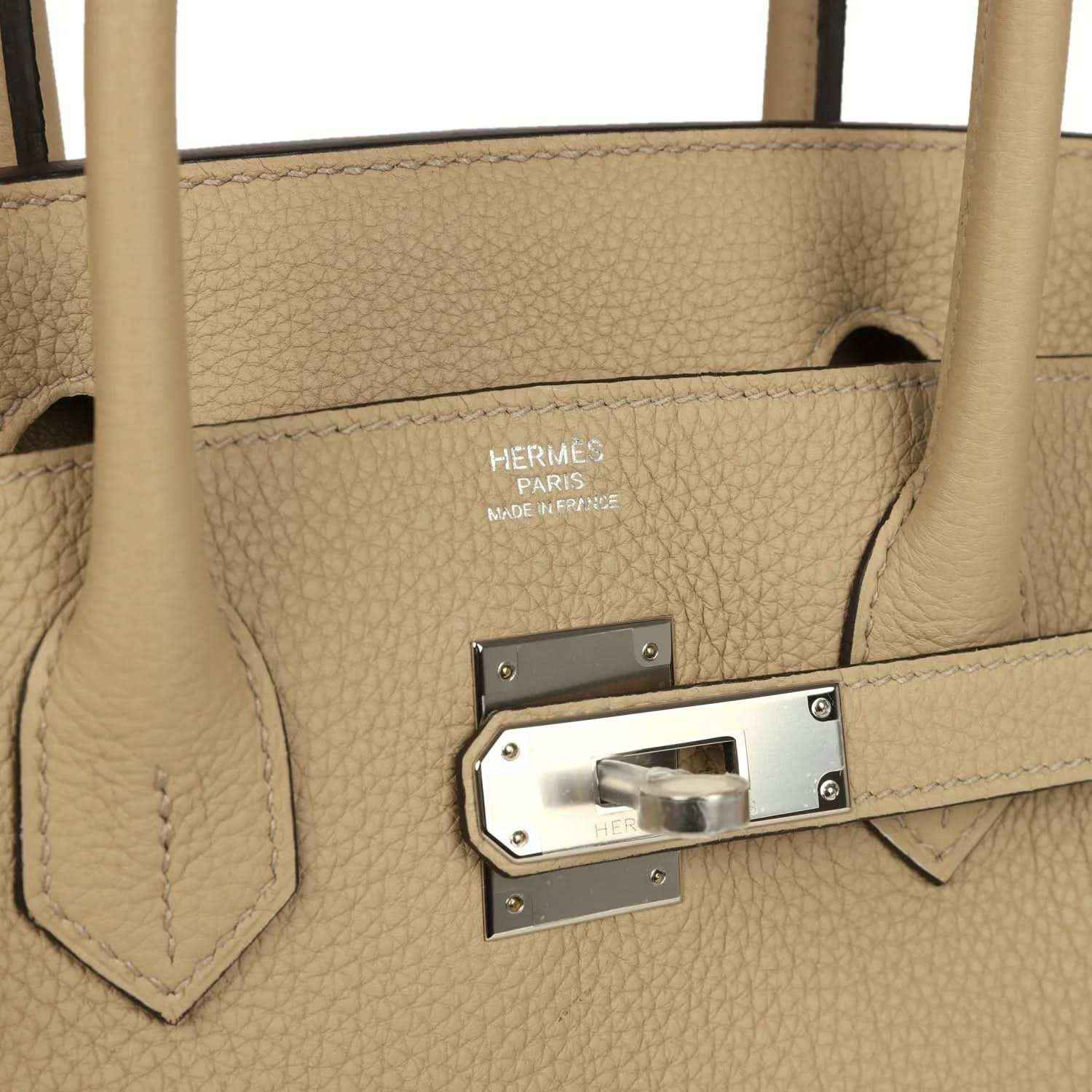 Tan leather handbag lining with HERMES stamp and metal lock plate hardware