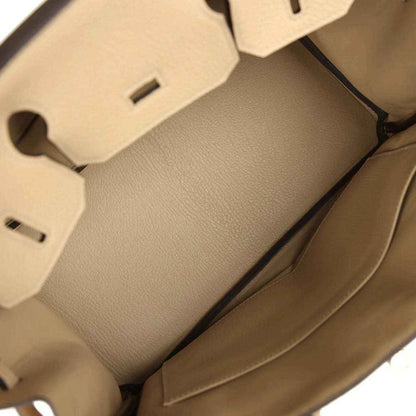 Tan leather handbag interior with stitched lining panels and side wall detail