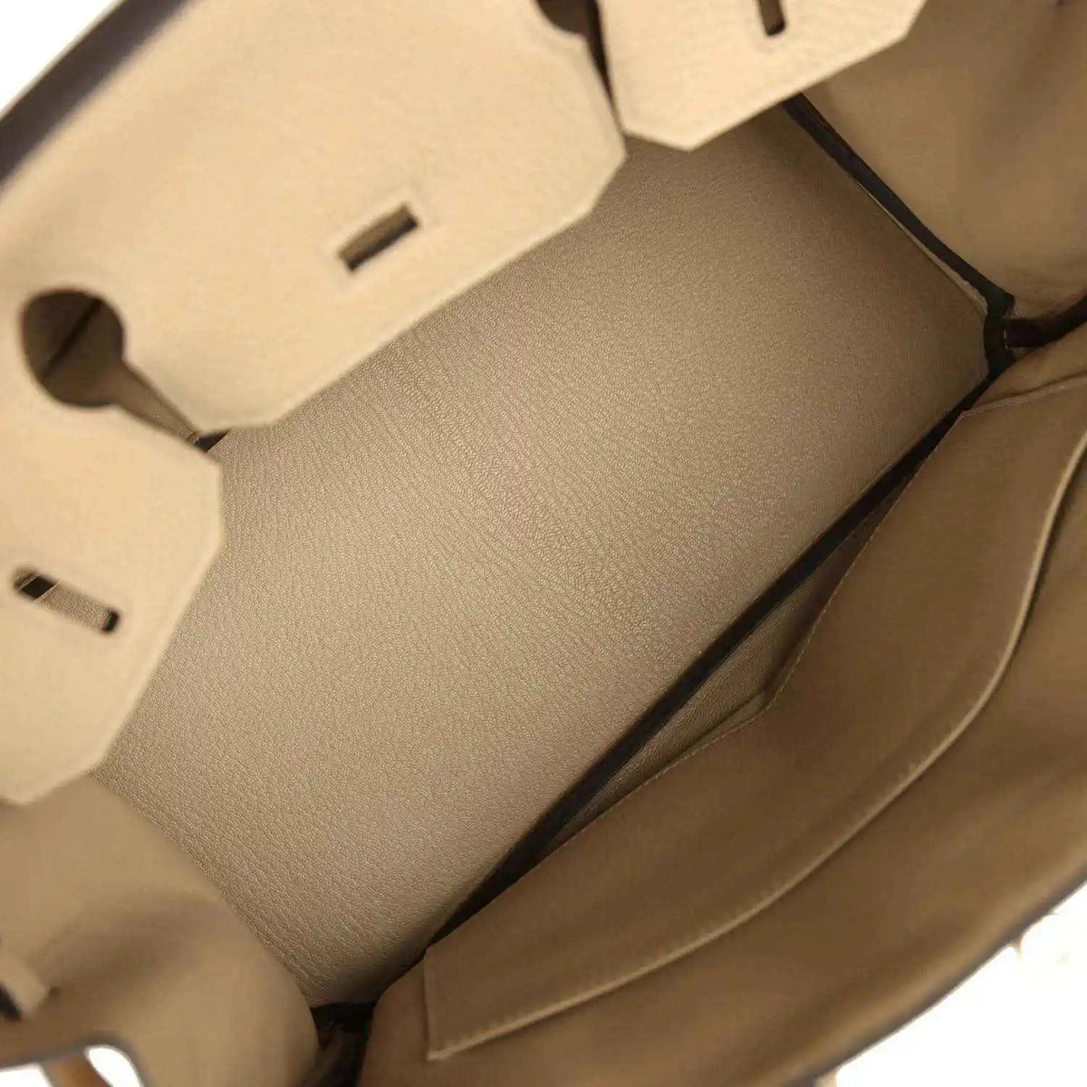 Tan leather handbag interior with stitched lining panels and side wall detail