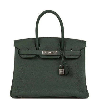Green leather handbag with top handles, front flap and turn-lock with dangling padlock