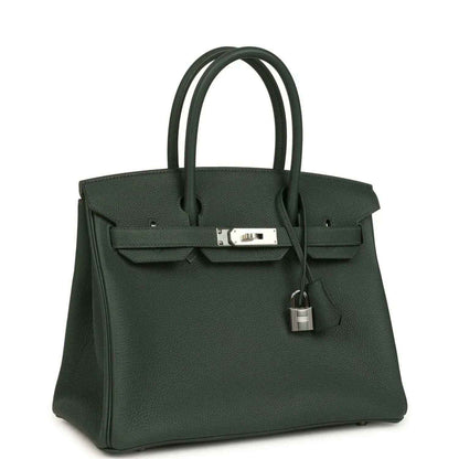 Green leather handbag with top handles, front flap and turn-lock hardware; padlock charm