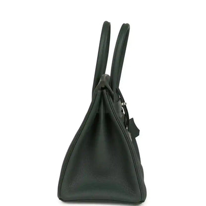 Green leather handbag side view with two top handles and structured silhouette