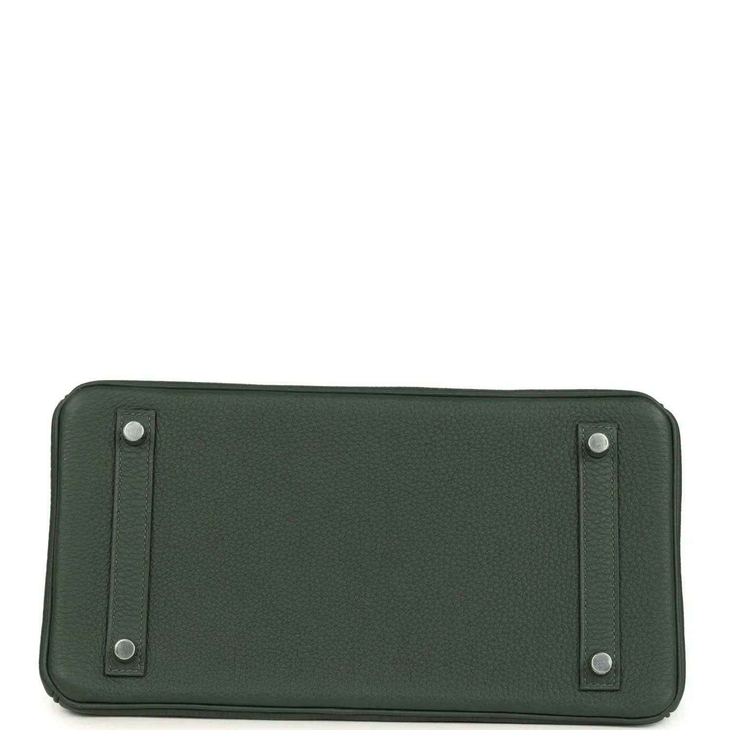 Green leather handbag base with stitched panels and four small metal feet