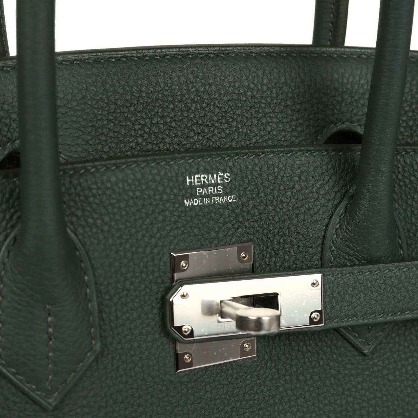 Green leather handbag interior label and turn-lock clasp with silver hardware