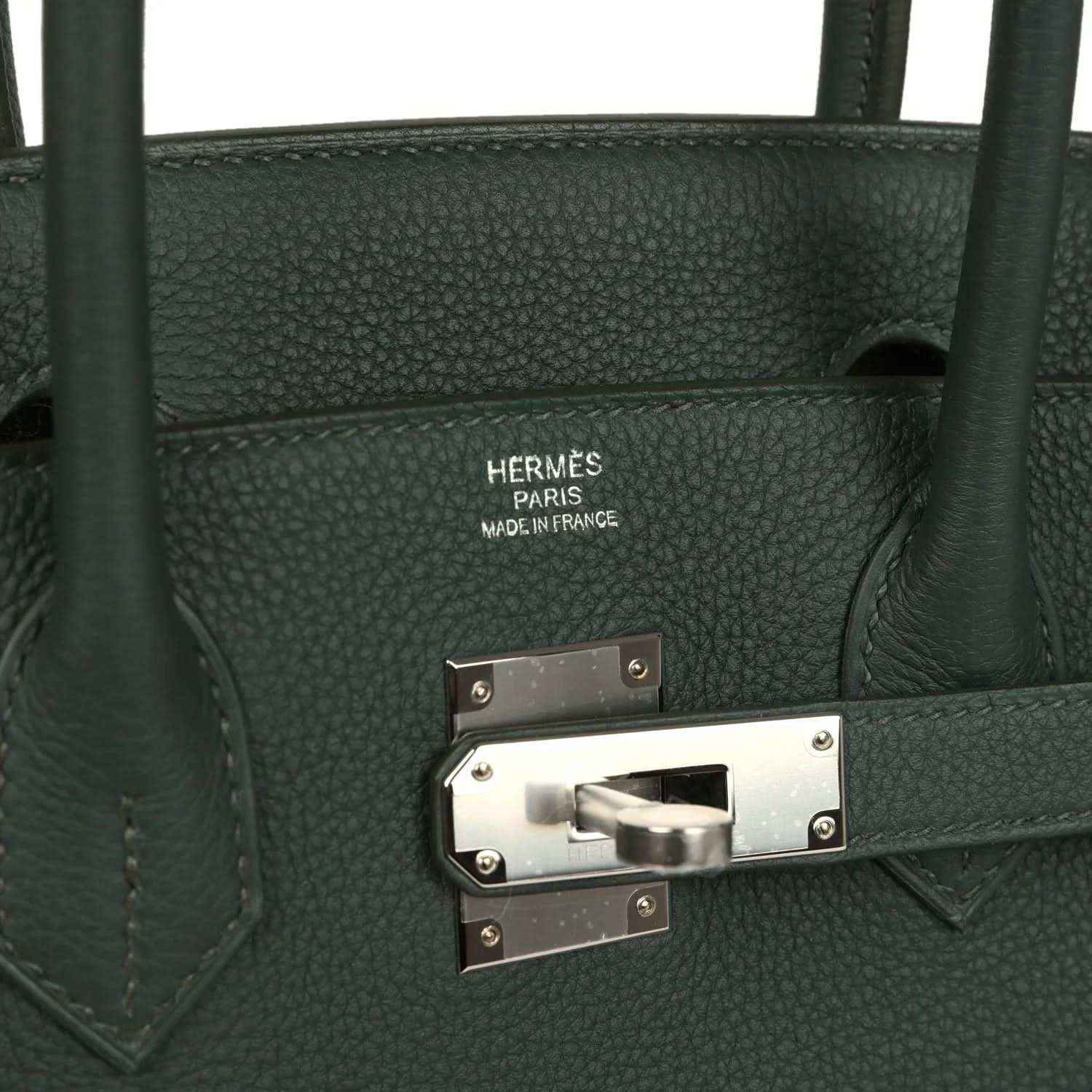 Green leather handbag interior label and turn-lock clasp with silver hardware